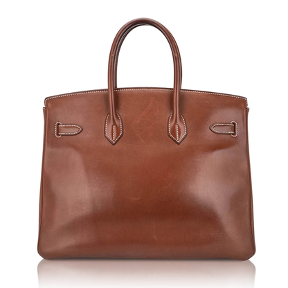 Warm Sunbaked Tan Organic Tonal Generous Sized Structured Hand Tote With Pale Contrast Stitching, Luminous Golden Twist Lock Hardware And Coordinating Tan Suspended Metal Padlock Charm