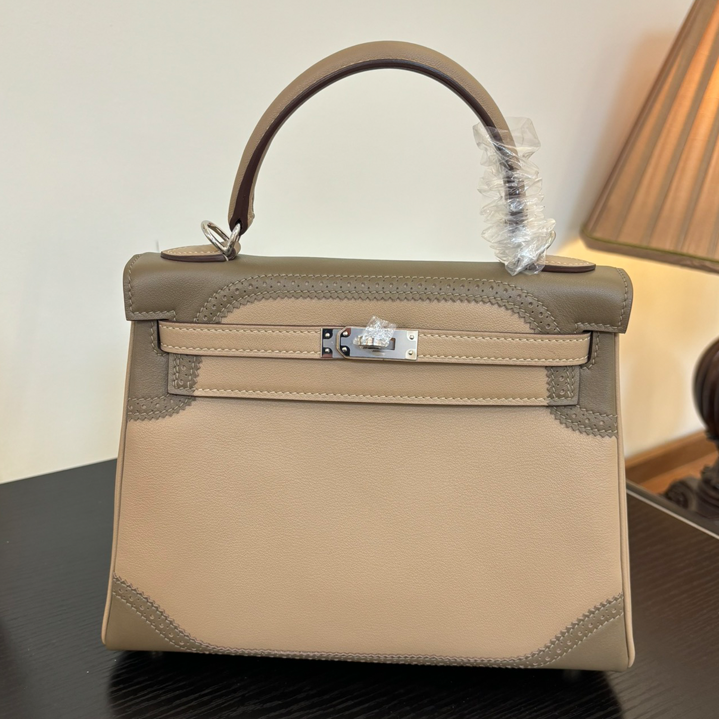 Soft Pale Beige Muted Taupe Two-Tone Compact Trapezoid Hand Tote With Perforated Stitched Trim And Sleek Silvery Twist Lock Hardware