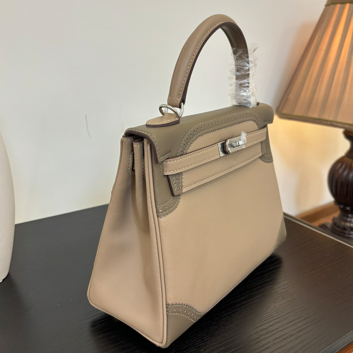 Soft Pale Beige Muted Taupe Two-Tone Compact Trapezoid Hand Tote With Perforated Stitched Trim And Sleek Silvery Twist Lock Hardware